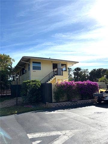 28230 Pine Haven Way, #68, Bonita Springs, FL 34135 View of front facade featuring a balcony