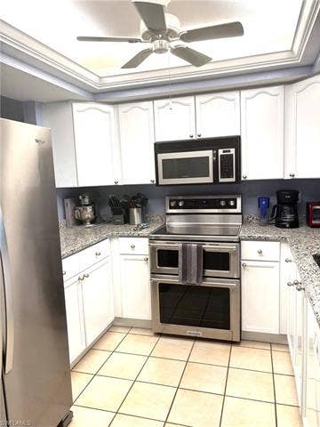 28230 Pine Haven Way, #68, Bonita Springs, FL 34135 Kitchen featuring light tile patterned flooring, white cabinetry, and stainless steel appliances