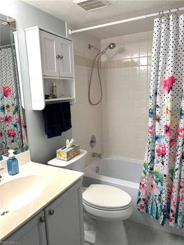 28230 Pine Haven Way, #68, Bonita Springs, FL 34135 Full bathroom featuring tile patterned floors, shower / bath combo with shower curtain, vanity, and toilet