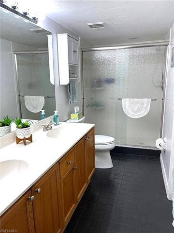 28230 Pine Haven Way, #68, Bonita Springs, FL 34135 Bathroom featuring toilet, vanity, tile patterned floors, and walk in shower