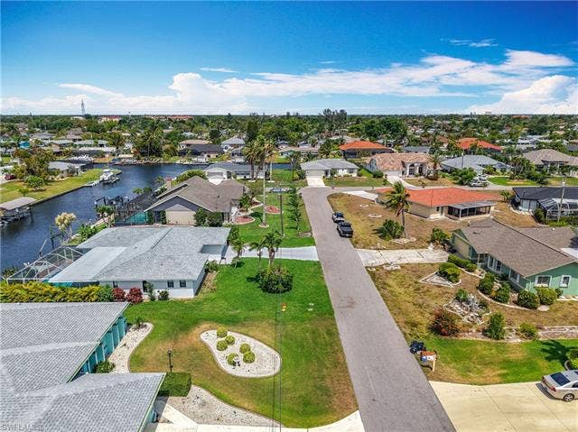 125 41st Ter, Cape Coral, FL 33904 Aerial perspective of suburban area with a large body of water