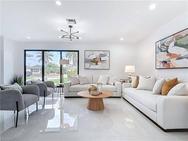 125 41st Ter, Cape Coral, FL 33904 Living room with recessed lighting and a chandelier