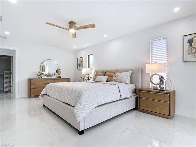 125 41st Ter, Cape Coral, FL 33904 Bedroom with light marble finish floors, recessed lighting, ceiling fan, and baseboards