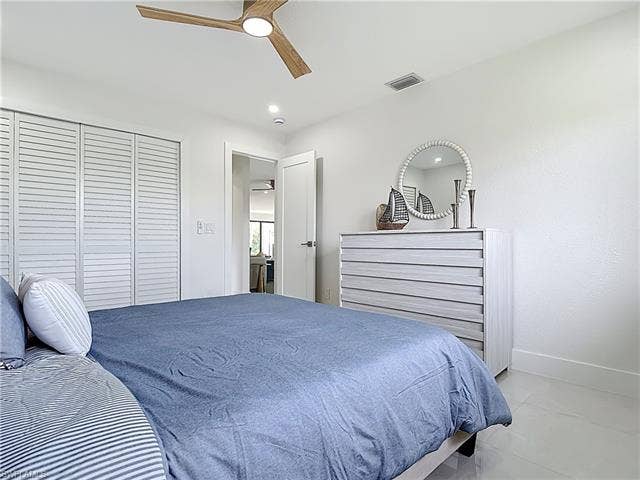 125 41st Ter, Cape Coral, FL 33904 Bedroom featuring baseboards, ceiling fan, and a closet