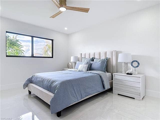 125 41st Ter, Cape Coral, FL 33904 Bedroom featuring baseboards, a ceiling fan, light marble finish floors, and recessed lighting