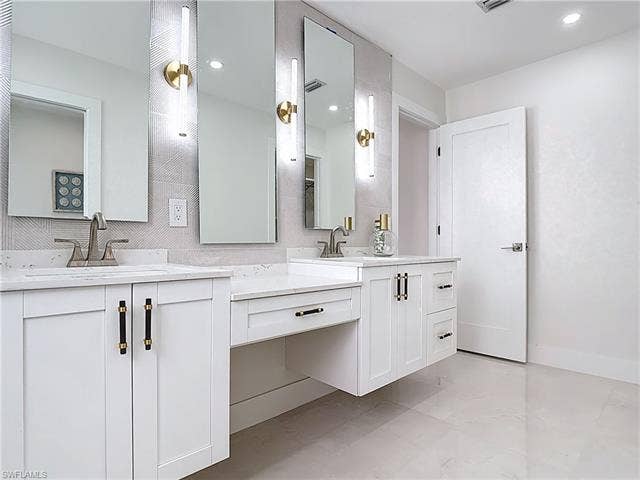 125 41st Ter, Cape Coral, FL 33904 Bathroom featuring two vanities