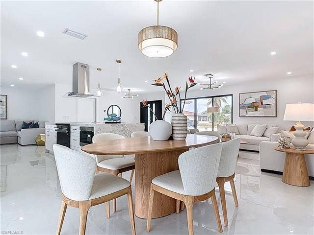 125 41st Ter, Cape Coral, FL 33904 Dining space featuring a chandelier and recessed lighting