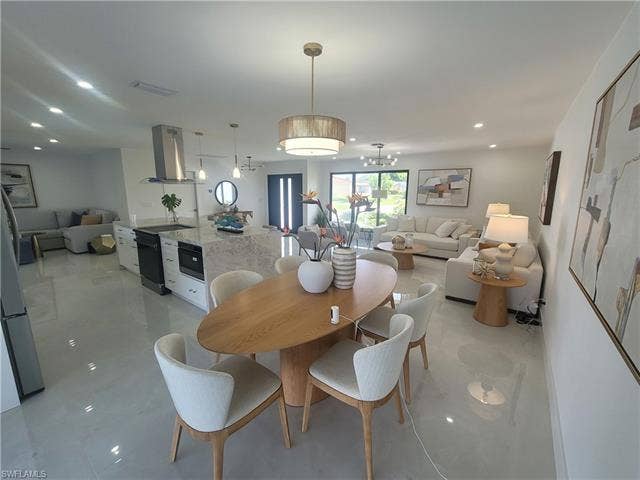125 41st Ter, Cape Coral, FL 33904 Dining room with recessed lighting, a chandelier, and light tile patterned floors