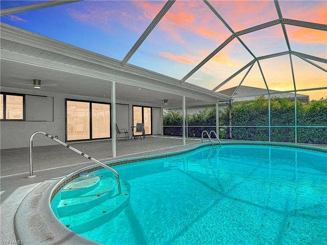 125 41st Ter, Cape Coral, FL 33904 Outdoor pool with a patio and glass enclosure