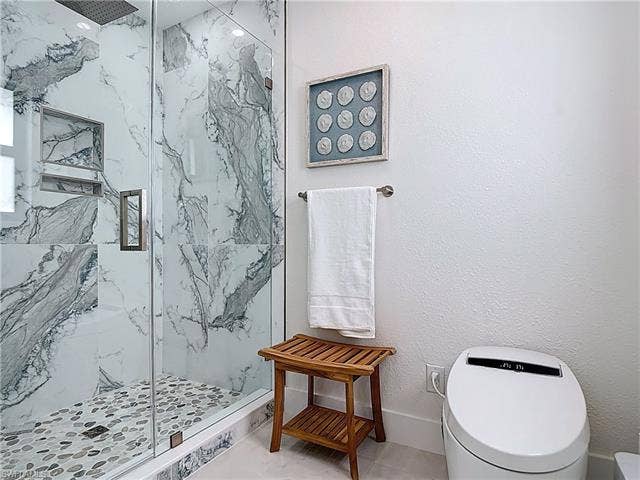 125 41st Ter, Cape Coral, FL 33904 Full bath with a marble finish shower and toilet