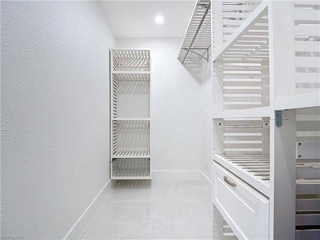 125 41st Ter, Cape Coral, FL 33904 Spacious closet featuring light marble finish flooring