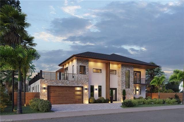 437 Heathwood Dr, Marco Island, FL 34145 Modern home featuring a balcony, stone siding, driveway, and stucco siding