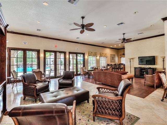 8510 Violeta St, #203, Estero, FL 34135 Living room featuring ornamental molding, ceiling fan, recessed lighting, a textured ceiling, and light tile patterned floors