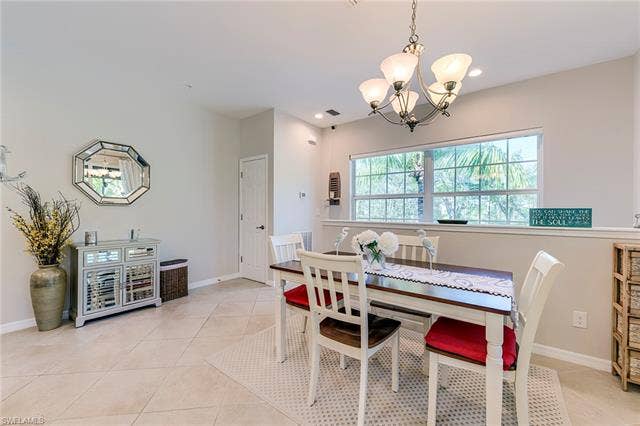 8510 Violeta St, #203, Estero, FL 34135 Dining space with light tile patterned flooring and a chandelier