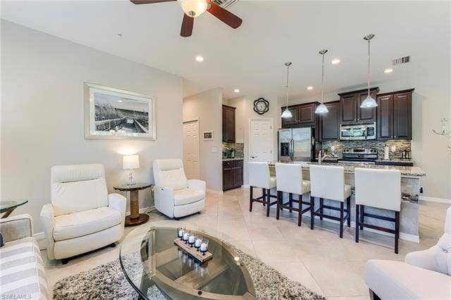 8510 Violeta St, #203, Estero, FL 34135 Living area with light tile patterned floors, ceiling fan, and recessed lighting