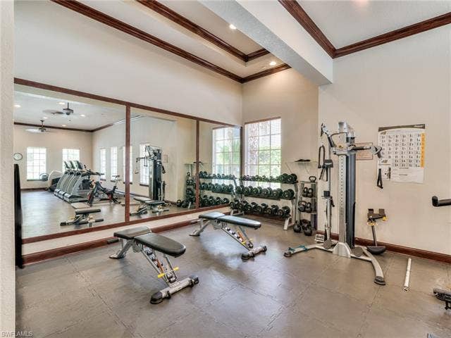 8510 Violeta St, #203, Estero, FL 34135 Workout area with crown molding, ceiling fan, and a high ceiling