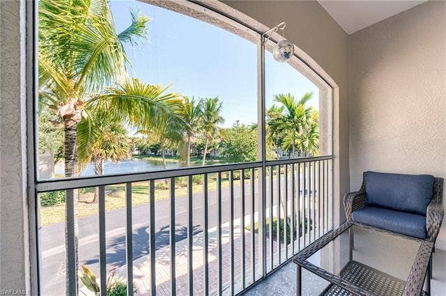 8510 Violeta St, #203, Estero, FL 34135 Balcony with a water view and a sunroom