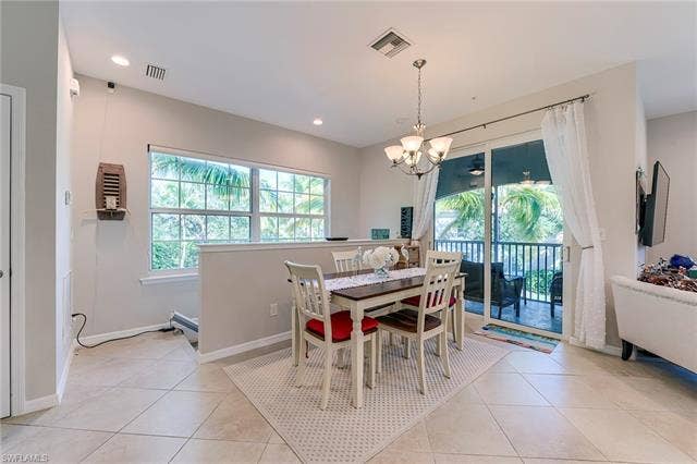 8510 Violeta St, #203, Estero, FL 34135 Dining space with light tile patterned floors, a chandelier, and recessed lighting