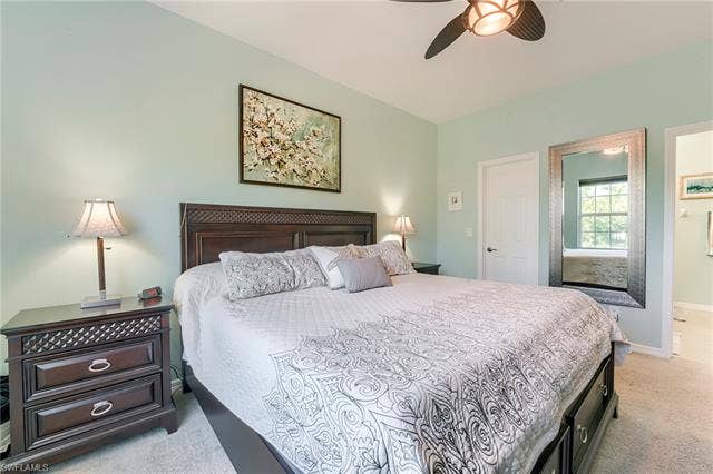 8510 Violeta St, #203, Estero, FL 34135 Bedroom with light carpet, a ceiling fan, and ensuite bathroom