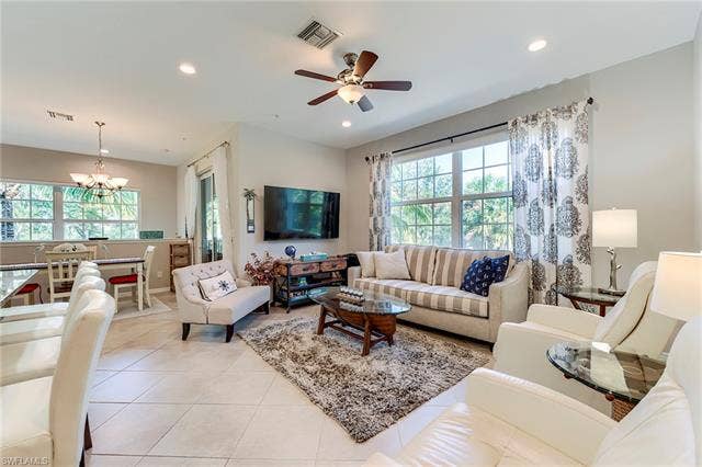 8510 Violeta St, #203, Estero, FL 34135 Living room with light tile patterned floors, a chandelier, recessed lighting, and a ceiling fan