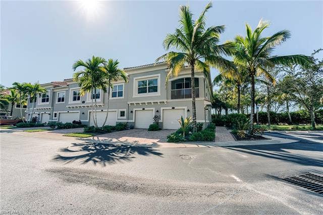 8510 Violeta St, #203, Estero, FL 34135 Mediterranean / spanish house with an attached garage, driveway, stucco siding, and a balcony