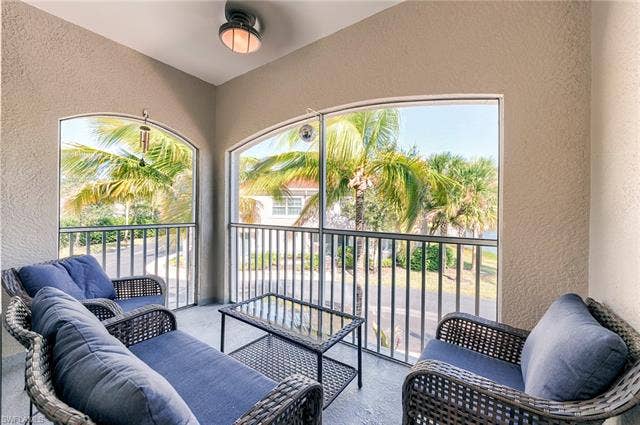 8510 Violeta St, #203, Estero, FL 34135 Balcony with a sunroom and an outdoor hangout area