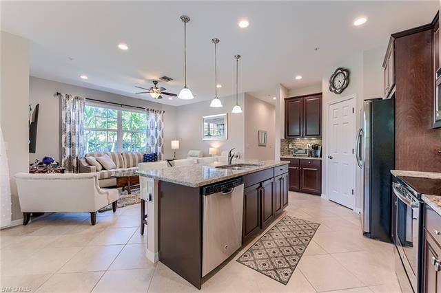 8510 Violeta St, #203, Estero, FL 34135 Kitchen with pendant lighting, appliances with stainless steel finishes, open floor plan, ceiling fan, and a kitchen island with sink