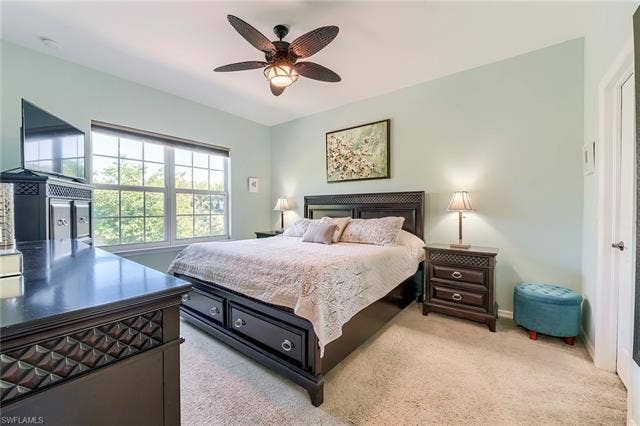 8510 Violeta St, #203, Estero, FL 34135 Bedroom with light colored carpet and a ceiling fan