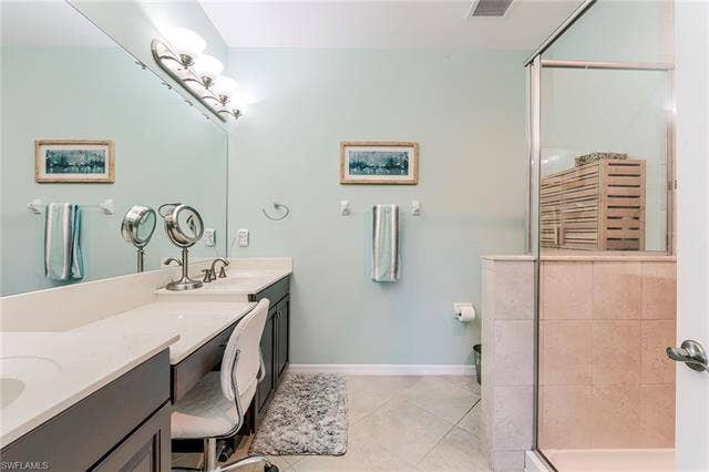 8510 Violeta St, #203, Estero, FL 34135 Bathroom with a shower stall, double vanity, and light tile patterned floors