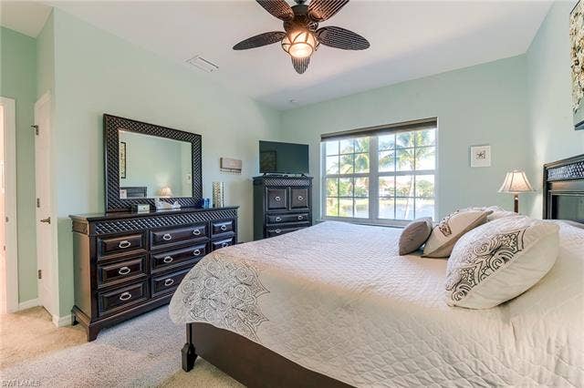 8510 Violeta St, #203, Estero, FL 34135 Bedroom with light colored carpet and a ceiling fan
