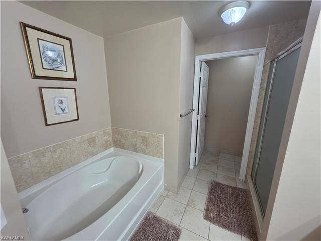 10127 Villagio Palms Way, #203, Estero, FL 33928 Full bathroom featuring a garden tub, light tile patterned floors, and a stall shower