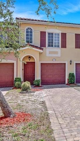 10127 Villagio Palms Way, #203, Estero, FL 33928 Mediterranean / spanish house featuring decorative driveway, an attached garage, and stucco siding