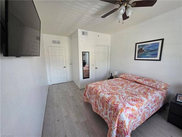 10127 Villagio Palms Way, #203, Estero, FL 33928 Bedroom featuring wood finished floors and ceiling fan