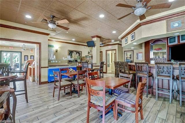 10127 Villagio Palms Way, #203, Estero, FL 33928 Dining area featuring recessed lighting, ceiling fan, light wood-style floors, and ornamental molding