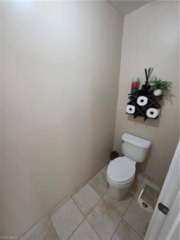 10127 Villagio Palms Way, #203, Estero, FL 33928 Bathroom with light tile patterned floors and toilet
