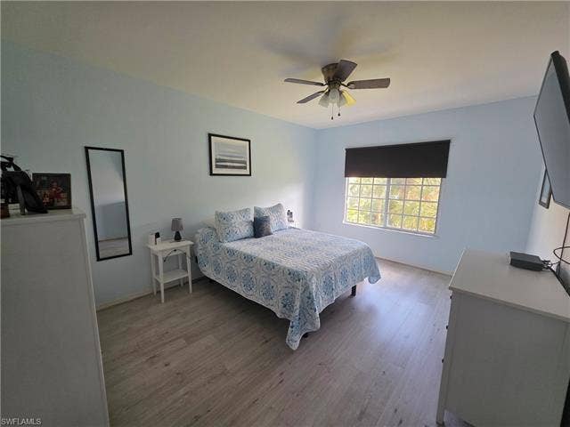 10127 Villagio Palms Way, #203, Estero, FL 33928 Bedroom featuring light wood-type flooring and ceiling fan