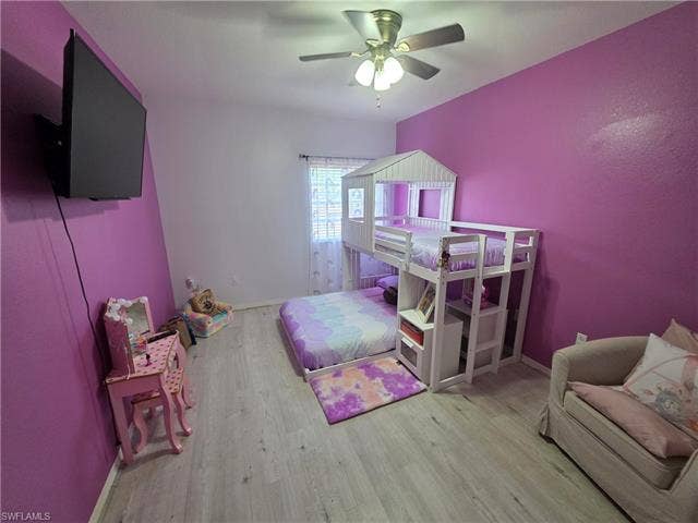 10127 Villagio Palms Way, #203, Estero, FL 33928 Bedroom featuring light wood-style floors and ceiling fan