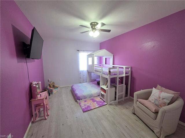 10127 Villagio Palms Way, #203, Estero, FL 33928 Bedroom featuring light wood-type flooring and a ceiling fan
