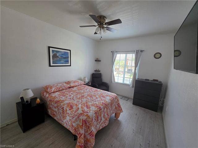 10127 Villagio Palms Way, #203, Estero, FL 33928 Bedroom featuring light wood finished floors and ceiling fan