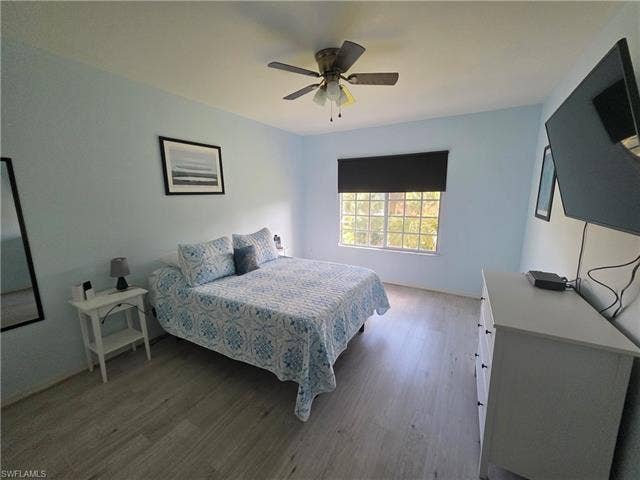 10127 Villagio Palms Way, #203, Estero, FL 33928 Bedroom with light wood finished floors and ceiling fan