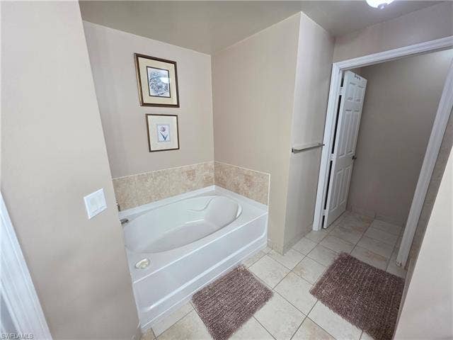 10127 Villagio Palms Way, #203, Estero, FL 33928 Bathroom featuring a bath and light tile patterned floors