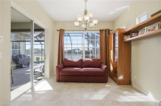 22140 Long Leaf Trail Dr, Estero, FL 34135 Sitting room with a water view, light tile patterned floors, a chandelier, and a sunroom