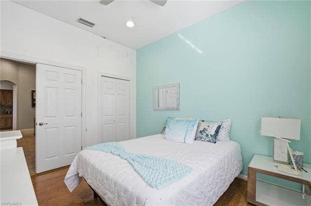 22140 Long Leaf Trail Dr, Estero, FL 34135 Bedroom featuring wood finished floors, a closet, a ceiling fan, and arched walkways