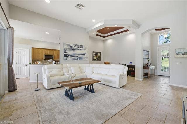 22140 Long Leaf Trail Dr, Estero, FL 34135 Living room with recessed lighting, arched walkways, and a high ceiling