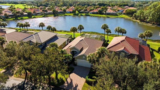 22140 Long Leaf Trail Dr, Estero, FL 34135 Aerial perspective of suburban area with a nearby body of water