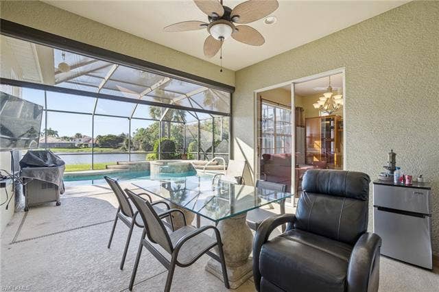 22140 Long Leaf Trail Dr, Estero, FL 34135 View of patio / terrace featuring a lanai, a sunroom, a water view, and ceiling fan