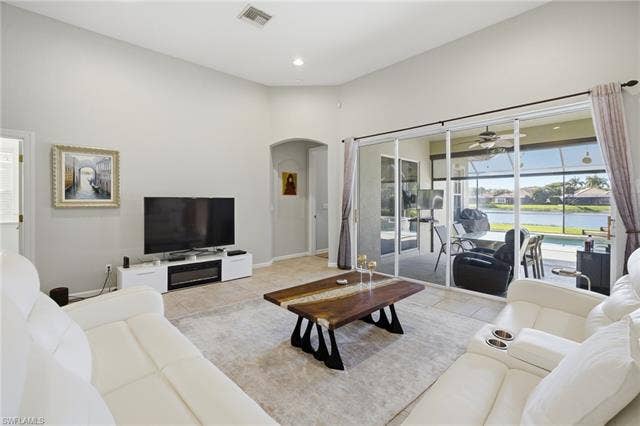 22140 Long Leaf Trail Dr, Estero, FL 34135 Living room with arched walkways, healthy amount of natural light, ceiling fan, recessed lighting, and light tile patterned floors