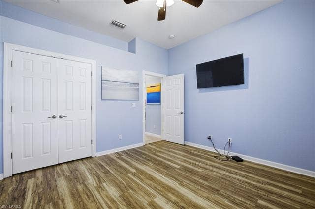 22140 Long Leaf Trail Dr, Estero, FL 34135 Unfurnished bedroom with wood finished floors, a closet, and ceiling fan