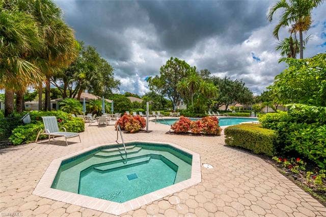 25735 Lake Amelia Way, #103, Bonita Springs, FL 34135 Community pool featuring a community hot tub and a patio area