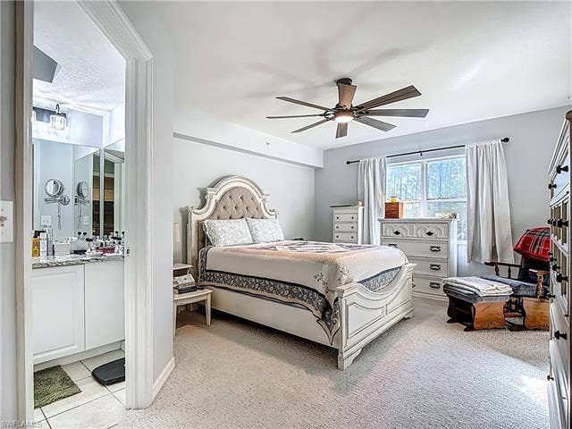 25735 Lake Amelia Way, #103, Bonita Springs, FL 34135 Bedroom with ceiling fan and light carpet
